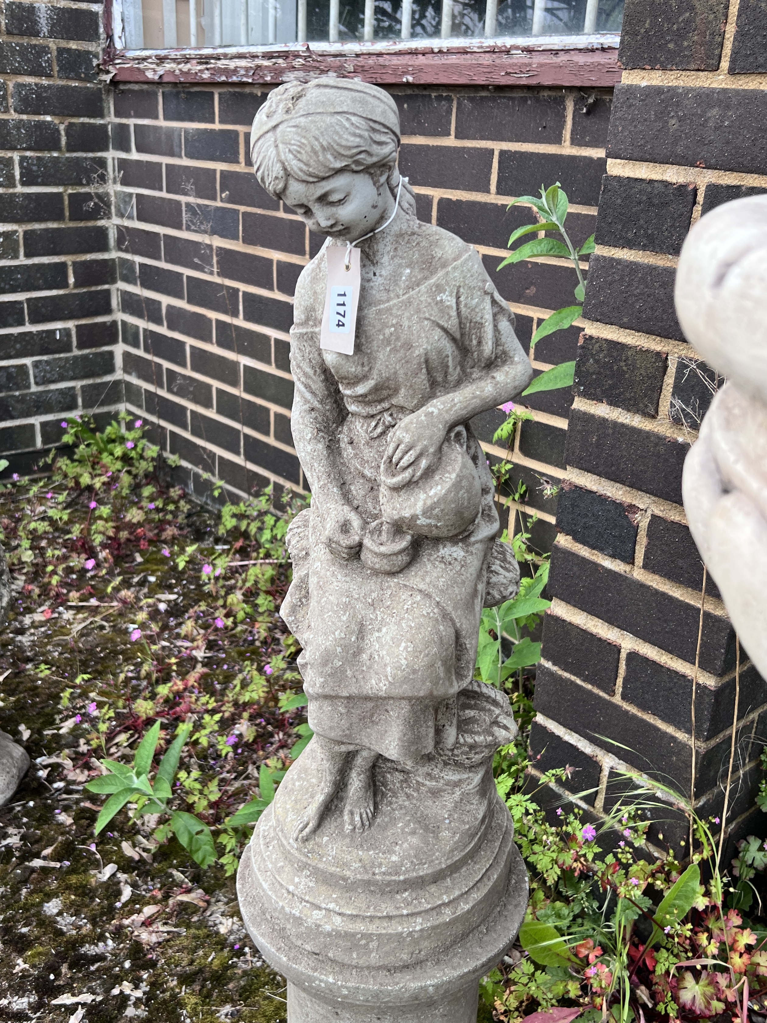 A reconstituted stone garden statue of a water girl, height 94cm